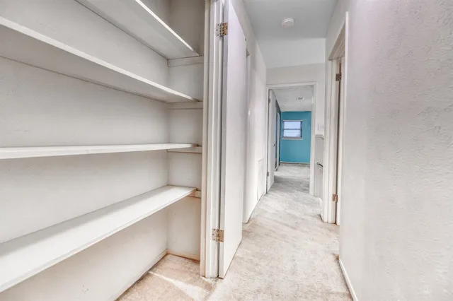 a view of a hallway with closet