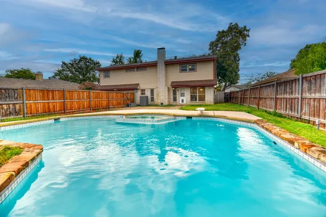 a swimming pool view with a outdoor seating