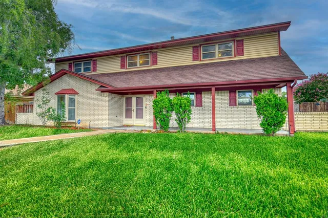 a front view of a house with a yard and porch