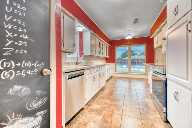 a view of a kitchen cabinets and a stove