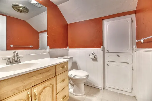 a bathroom with a sink a toilet and a mirror