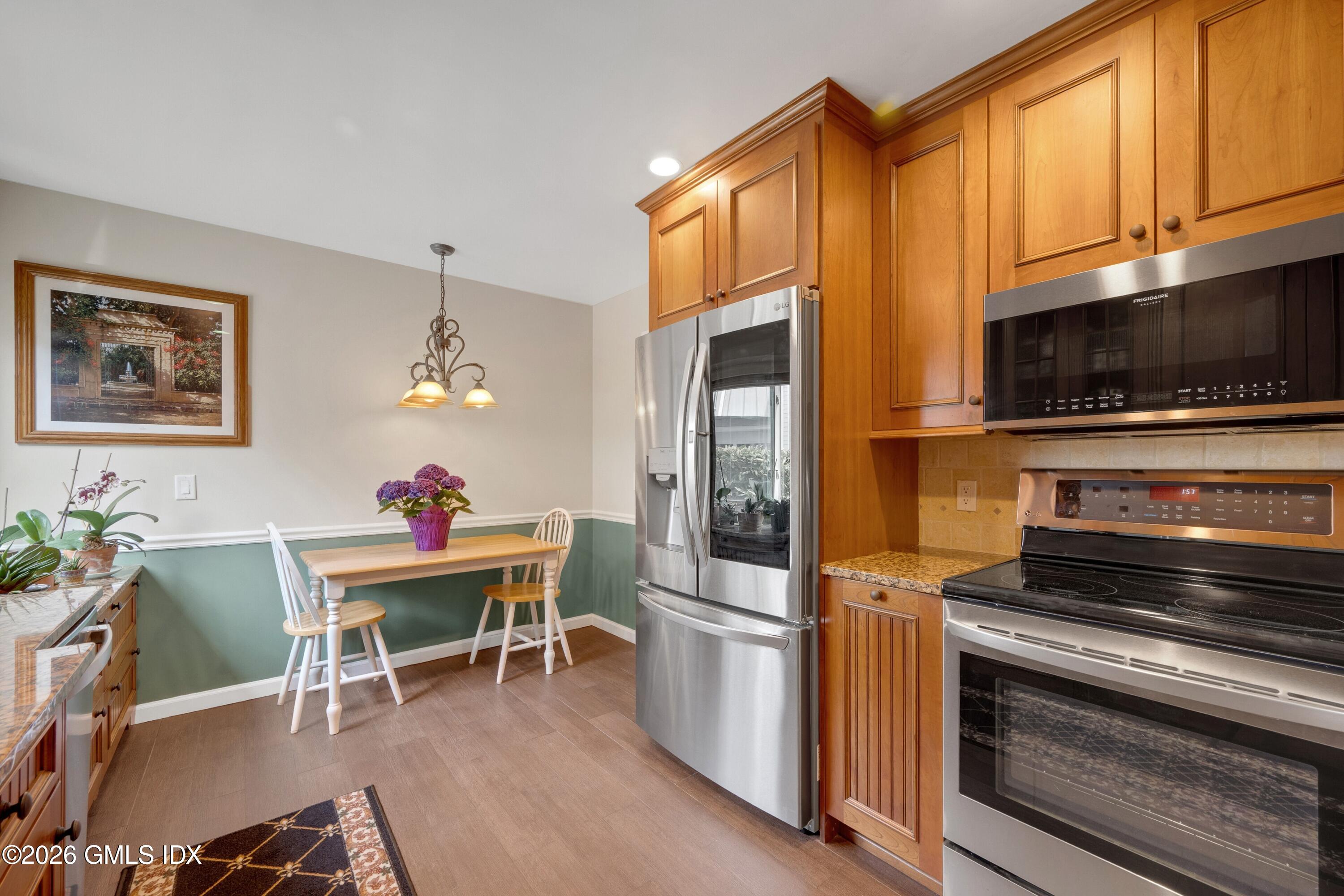 58 Stirrup Lane, Unit 58 Riverside, CT 06878 - Photo 3 of 23 a kitchen with stainless steel appliances a stove a sink refrigerator and a microwave