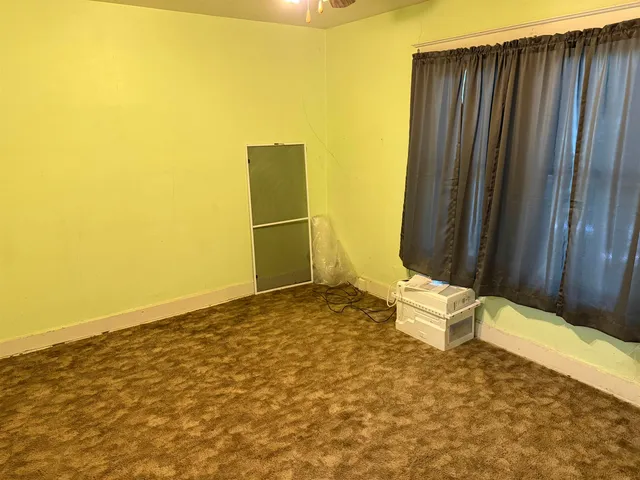 a view of room with stairs and wooden floor
