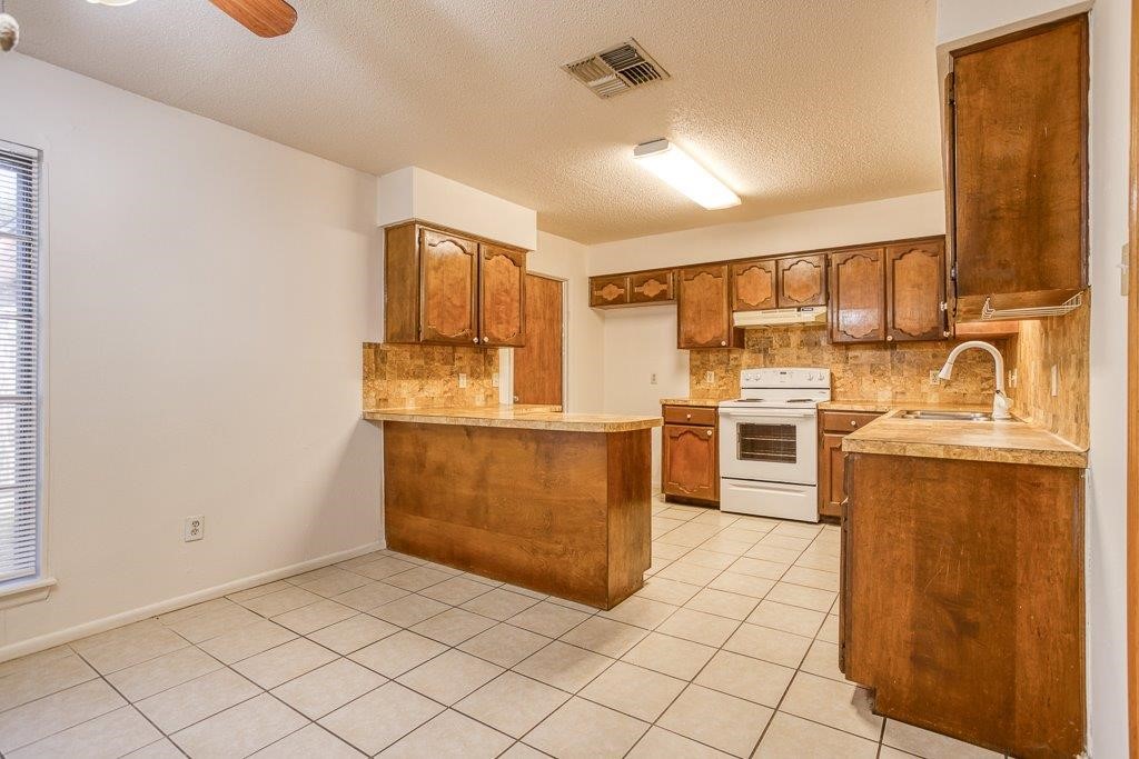 102 Timber Trail Circle Portland, TX 78374 - Photo 14 of 28 a kitchen with granite countertop cabinets and steel appliances