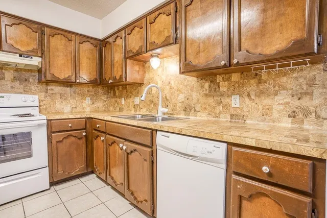 a kitchen with stainless steel appliances granite countertop a sink and cabinets