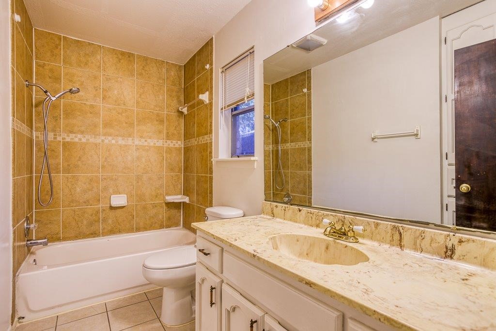 102 Timber Trail Circle Portland, TX 78374 - Photo 19 of 28 a bathroom with a granite countertop toilet sink and mirror