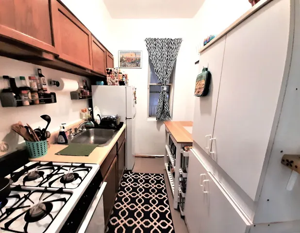 a kitchen with a refrigerator and a stove