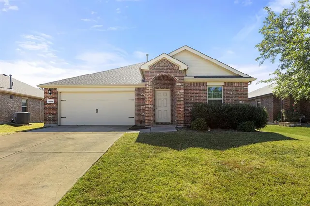 a front view of house with yard and trees