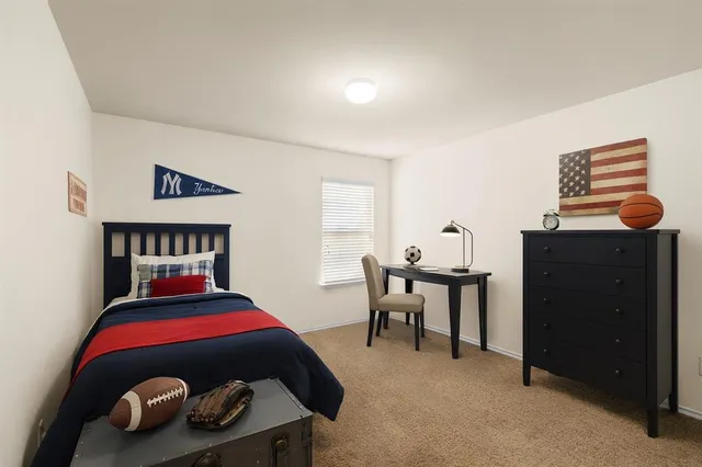 a bedroom with a bed and a table in it