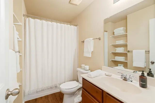 a bathroom with a sink toilet and shower