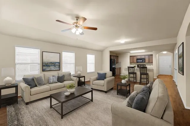 a living room with furniture and a large window