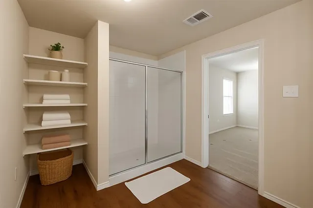 a view of an empty room with a closet