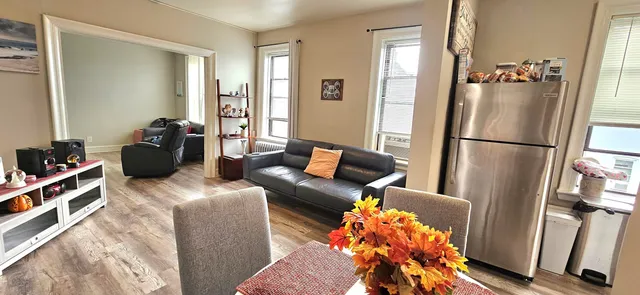 a living room with furniture flowerpot and a window