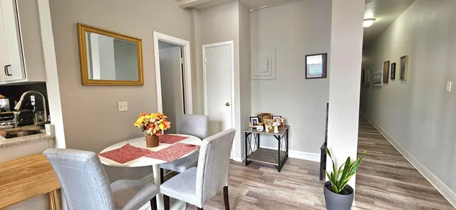 a view of a dining room with furniture and wooden floor