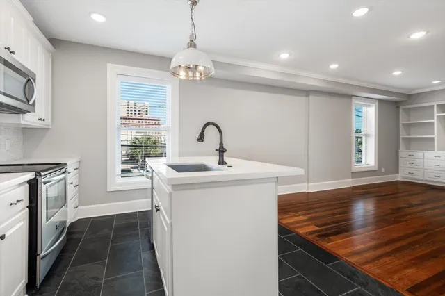 a kitchen with a sink and a refrigerator