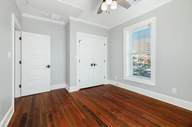 wooden floor in an empty room with a window