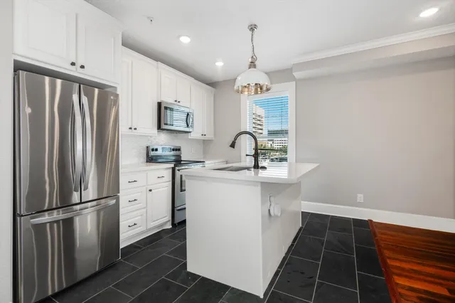 a kitchen with a sink and chandelier