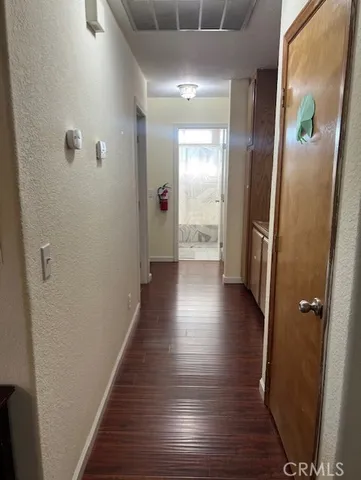 a view of a hallway with wooden floor