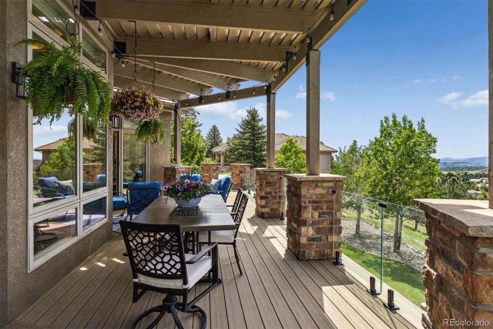 16422 Rocky Point Lane Morrison, CO 80465 - Photo 12 of 50 a view of a patio with table and chairs and wooden floor