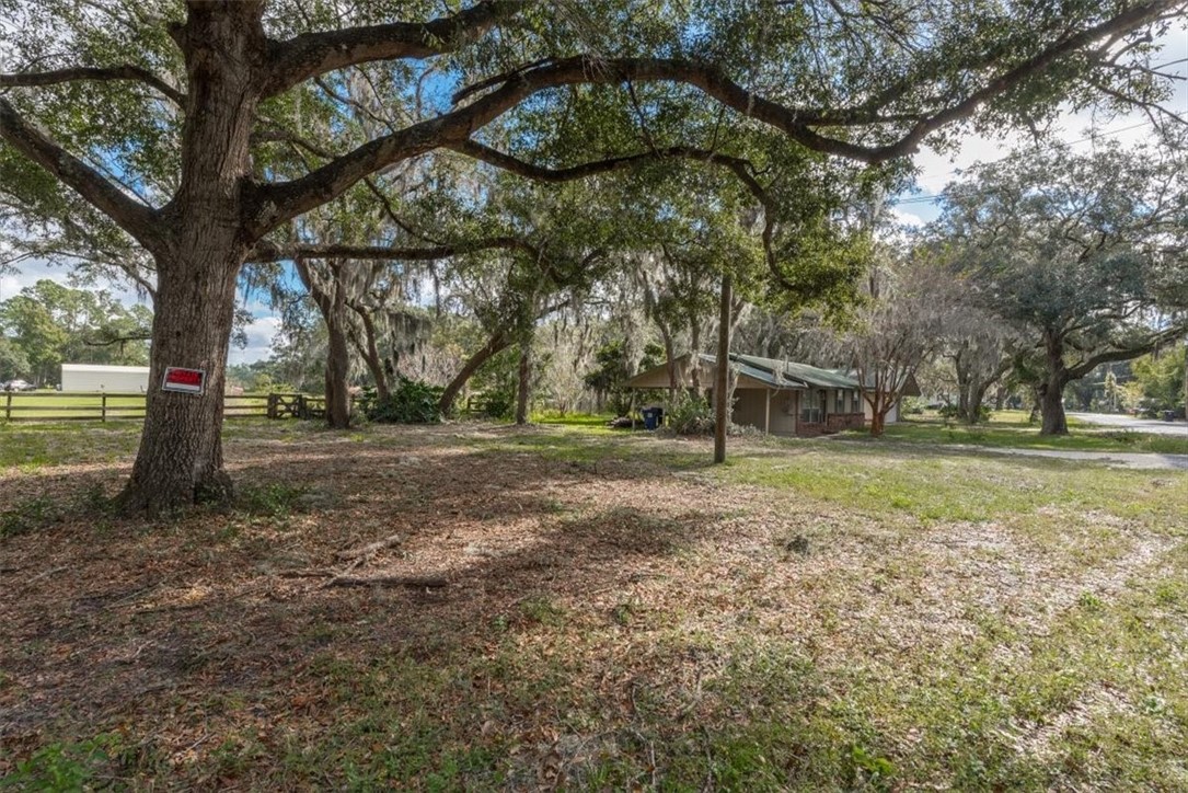 85186 Winona Bayview Road Yulee, FL 32097 - Photo 22 of 24 a view of outdoor space with deck and trees