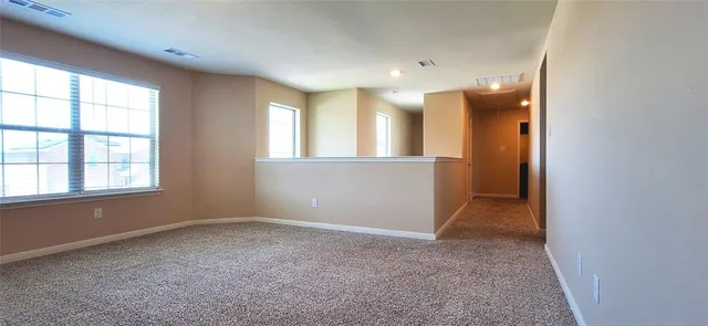 an empty room with windows and entrance