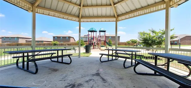 a view of a chairs and table in the patio