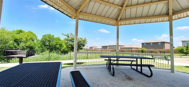 a view of a chair and table on the deck