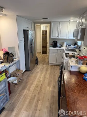 a kitchen with a refrigerator and a sink