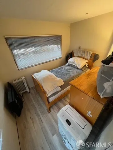 a view of a room with wooden floor and furniture