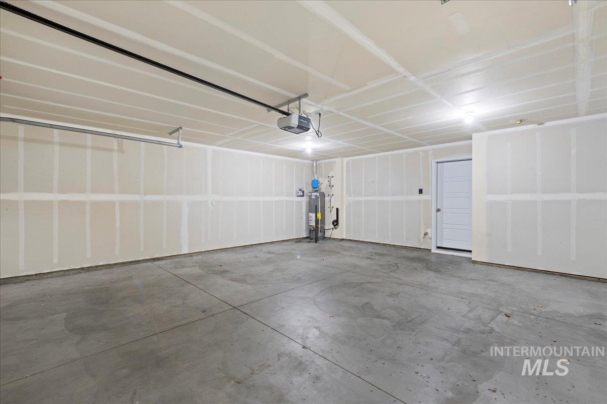 2513 East Goldstone Street Meridian, ID 83642 - Photo 11 of 27 Garage with water heater and a garage door opener
