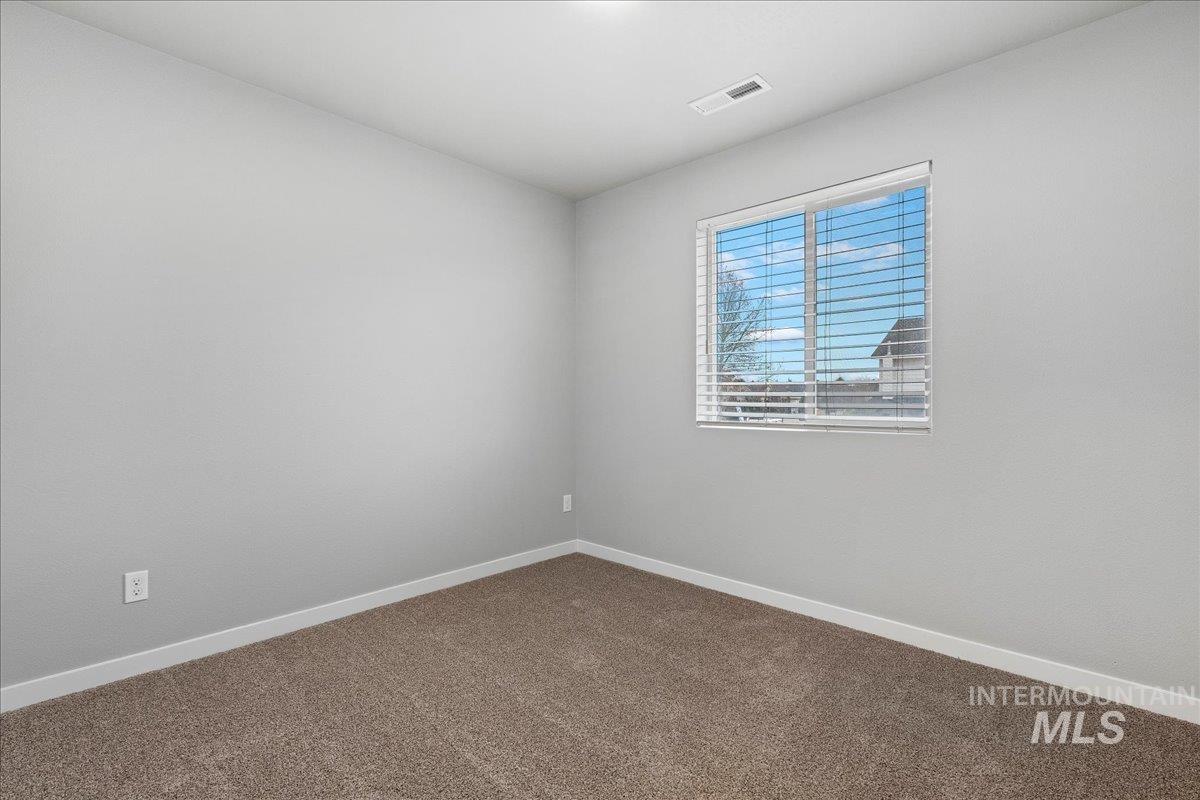 2513 East Goldstone Street Meridian, ID 83642 - Photo 13 of 27 Empty room featuring baseboards and carpet
