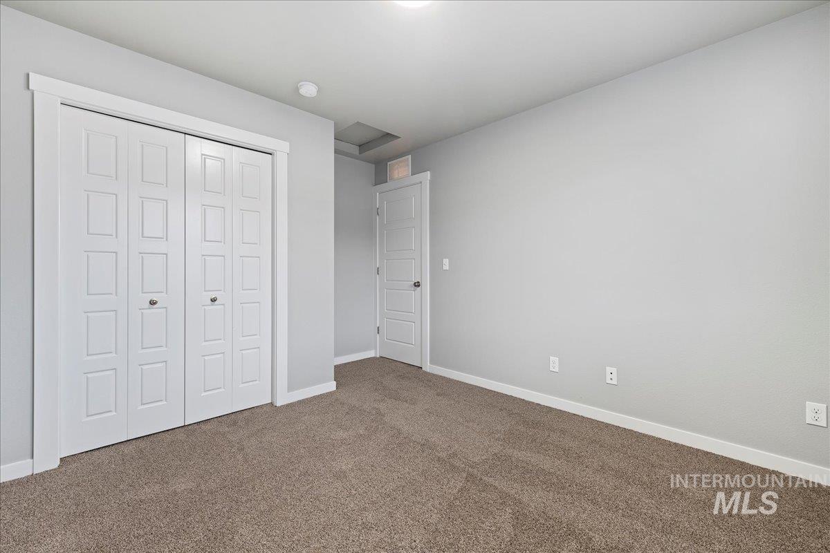 2513 East Goldstone Street Meridian, ID 83642 - Photo 16 of 27 Unfurnished bedroom featuring carpet floors and a closet
