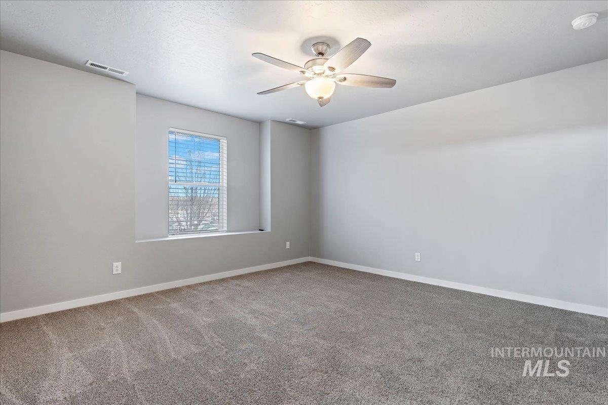 2513 East Goldstone Street Meridian, ID 83642 - Photo 20 of 27 Unfurnished room with carpet flooring and ceiling fan