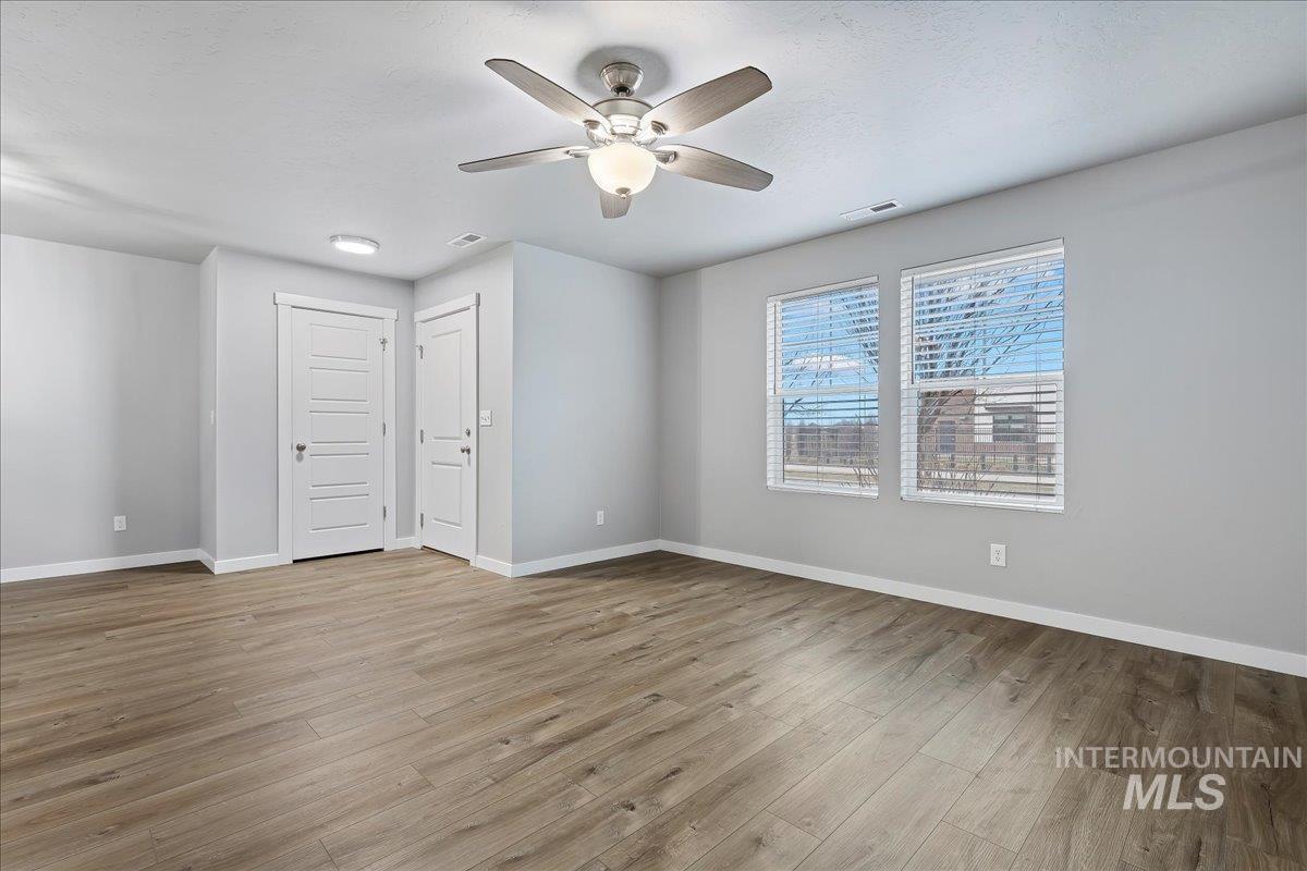 2513 East Goldstone Street Meridian, ID 83642 - Photo 23 of 27 Unfurnished room featuring a ceiling fan and light wood-style floors
