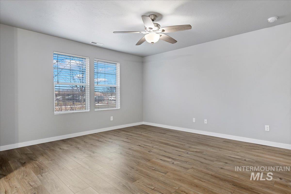 2513 East Goldstone Street Meridian, ID 83642 - Photo 5 of 27 Unfurnished room featuring ceiling fan and light wood-type flooring