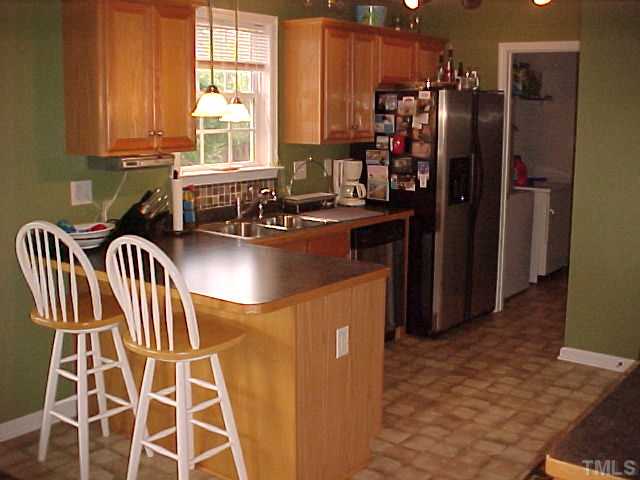 7219 Sunset View Court Willow Spring, NC 27592 - Photo 7 of 24 BREAKFAST BAR AND SEPERATE LAUNDRY ROOM