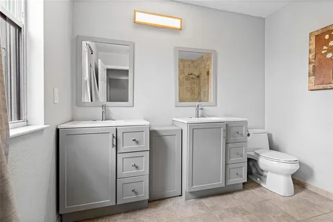 a bathroom with a toilet sink and mirror