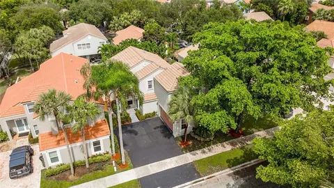 an aerial view of multiple houses with yard
