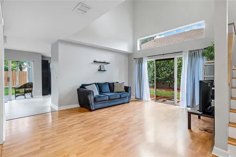 a living room with furniture and a floor to ceiling window