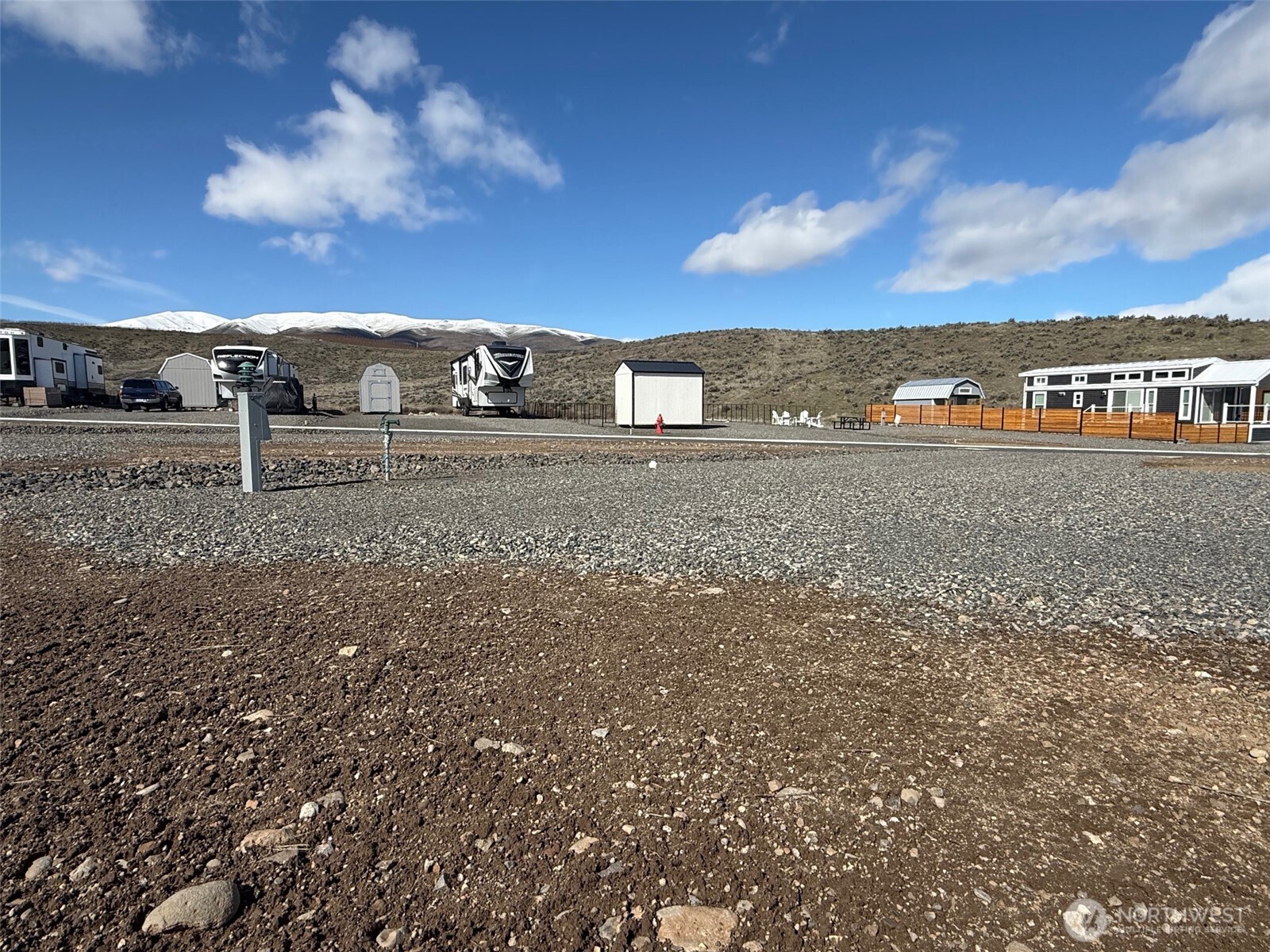 1769 Naches Wenas Road, Unit 144 Selah, WA 98942 - Photo 3 of 12 a view of a dry yard with wooden fence