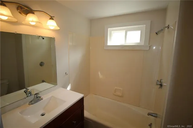 a bathroom with a sink a shower and a mirror