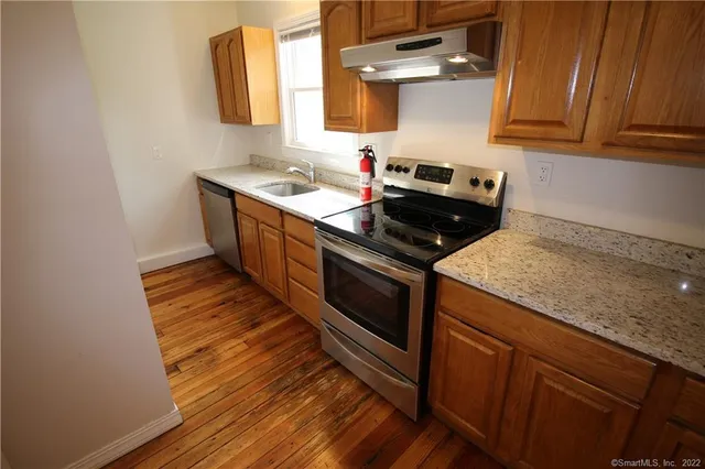 a kitchen with a sink stove and cabinets