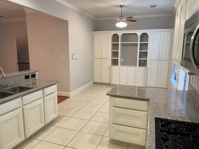 a kitchen with stainless steel appliances granite countertop a refrigerator and a stove