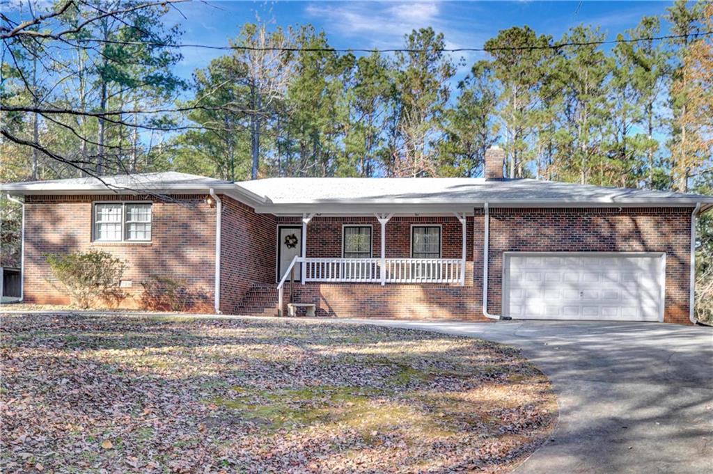 a view of house with backyard and a garden