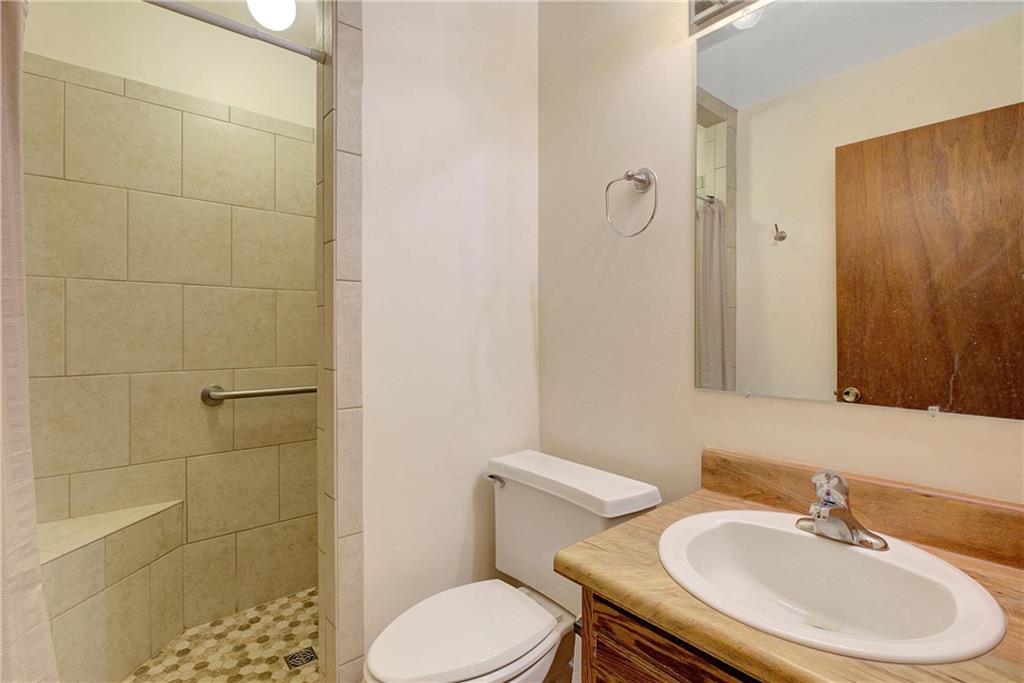 10185 Henry Mill Road Chattahoochee Hills, GA 30213 - Photo 15 of 41 a bathroom with a sink a toilet and a mirror