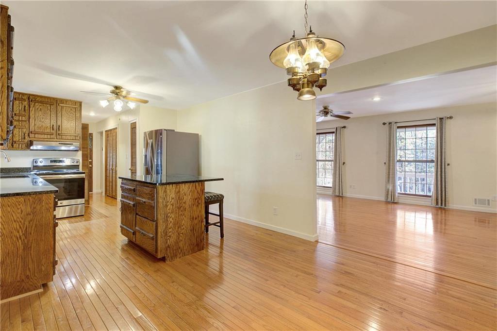 10185 Henry Mill Road Chattahoochee Hills, GA 30213 - Photo 17 of 41 a view of a dining room with furniture wooden floor and chandelier