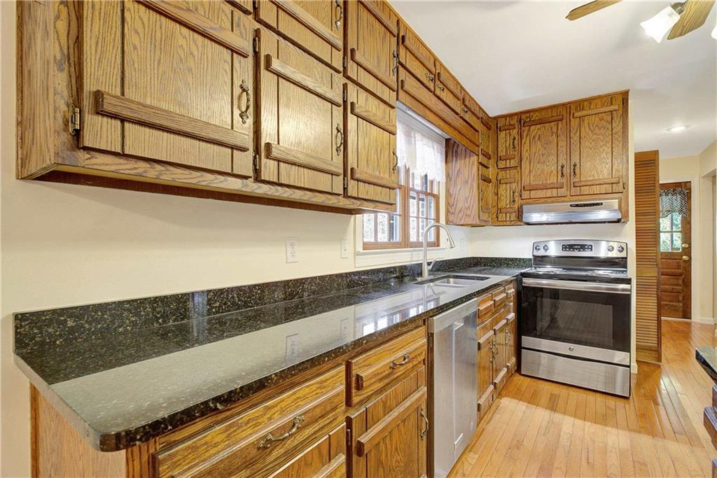 10185 Henry Mill Road Chattahoochee Hills, GA 30213 - Photo 21 of 41 a kitchen with stainless steel appliances granite countertop a sink and cabinets