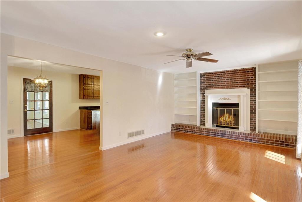 10185 Henry Mill Road Chattahoochee Hills, GA 30213 - Photo 3 of 41 a view of an empty room with a fireplace and a window