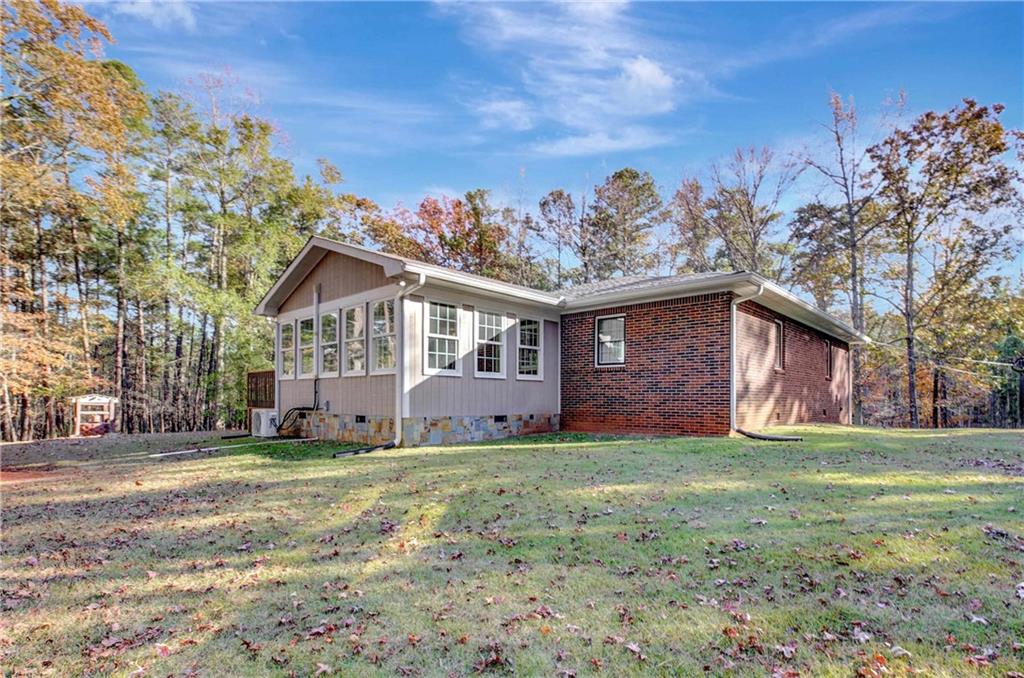 10185 Henry Mill Road Chattahoochee Hills, GA 30213 - Photo 31 of 41 a view of a house with a yard