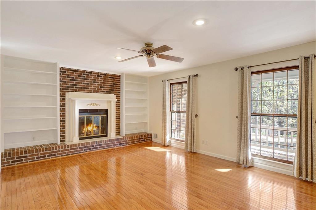10185 Henry Mill Road Chattahoochee Hills, GA 30213 - Photo 4 of 41 a view of an empty room with a fireplace and a window